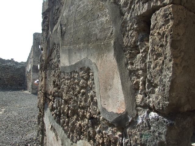 IX.2.17 Pompeii. March 2009. North wall of entrance corridor, with small traces of plaster, coloured red.