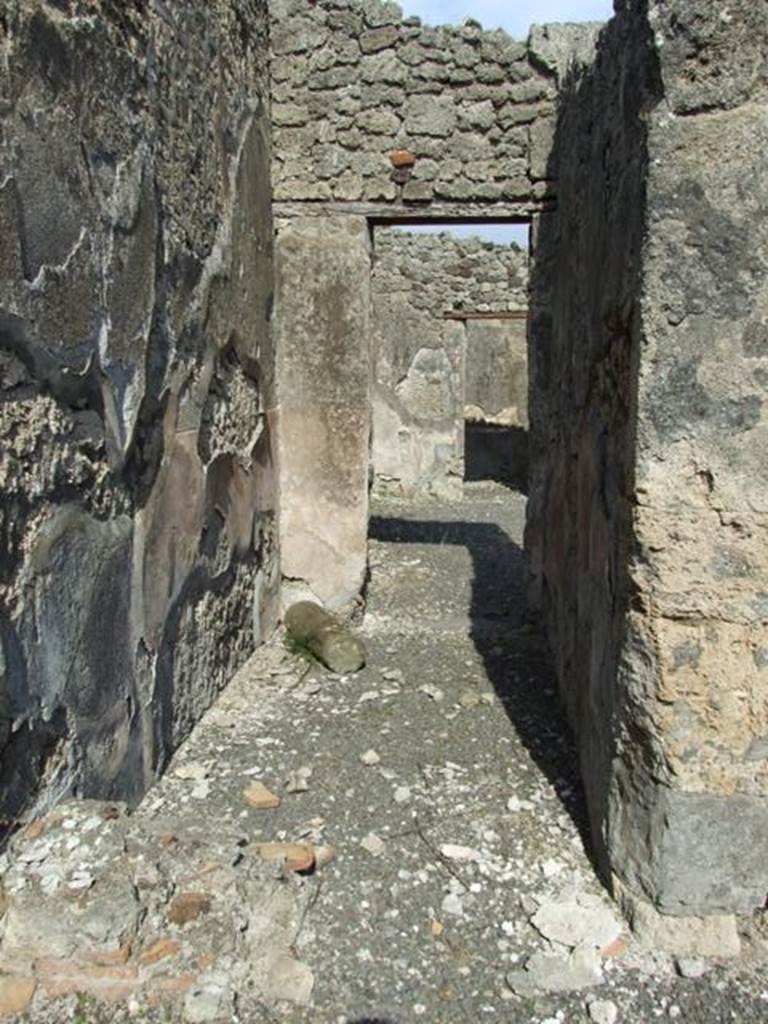 IX.2.18 Pompeii. March 2009. Room 13, corridor to atrium. The remains of the lower masonry steps (in the lower left) would have lead to the rooms on the upper floor via a wooden staircase. The line of the stairs can be seen in the remaining plaster of the left wall. 

