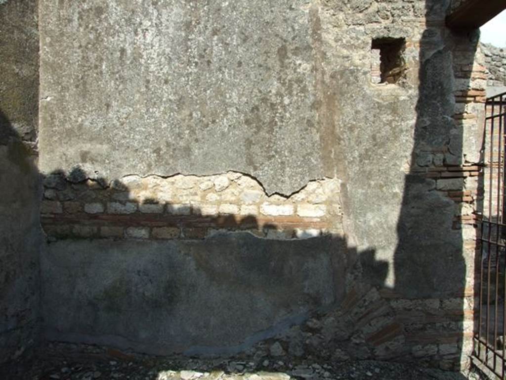 IX.2.18 Pompeii. March 2009. Room 2, cubiculum, east wall, with small window to Vicolo di Tesmo. On the right is the doorway from the entrance corridor, which would have given access to stairs to the upper floor.
