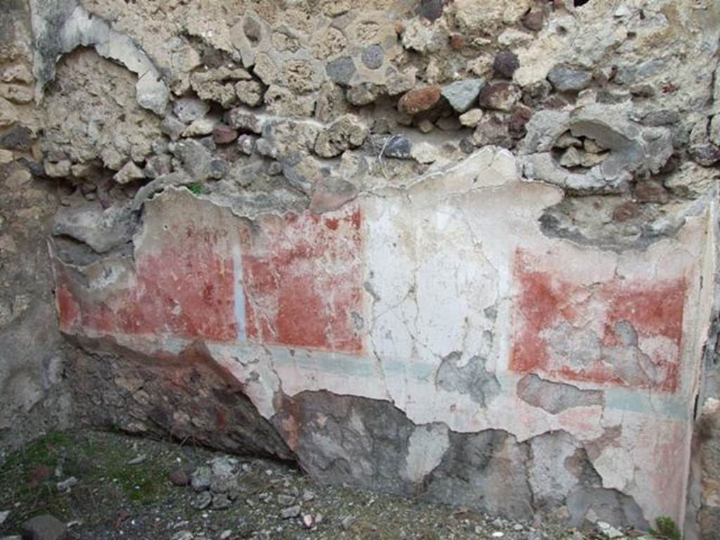 IX.2.21 Pompeii. March 2009. Room 13, north wall of cubiculum. According to Bragantini, the dado would have been red, and in the middle zone of the north wall was a white central aedicula. On both sides of it, the panels were red. The upper zone of the wall would have been white. The panel on the west end was sub-divided by a candelabra which formed the recess wall. At the base of the middle zone was an azure blue line. In the white panel, a painted female figure near an archaic herm of Dionysus, was seen.
See Sogliano, A., 1879. Le pitture murali campane scoverte negli anni 1867-79. Napoli: Giannini. (p.52, no.243) 
See Bragantini, de Vos, Badoni, 1986. Pitture e Pavimenti di Pompei, Parte 3. Rome: ICCD. (p.424, cubicolo ‘m’)
