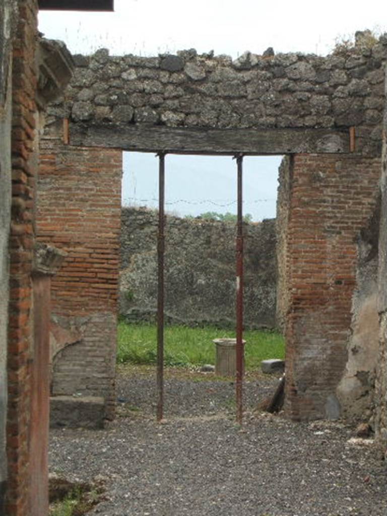 IX.2.26 Pompeii. May 2005. Looking south through the tablinum to garden area.
According to Bragantini, the lava base for the arca, or moneychest, can be seen at the base of the pilaster, on the left. See Bragantini, de Vos, Badoni, 1986. Pitture e Pavimenti di Pompei, Parte 3. Rome: ICCD. (p.426, atrio ‘d’).
According to Fiorelli, a walkway preceded the large garden located behind the atrium, and on this walkway was a terrace with rooms, in which many men and women too refuge, whose rich jewellery, rings and pendants of gold, along with nine skeletons were found on the 18th and 20th November 1869. Of all graffiti, together with isolated names, that one could read on the pillars of this walkway, the most important was the one that contained the verse of the Aeneid (I.234):
CERTE . HINC . ROMANOS. OLIM
VOLENTIBVS ANNIIIS
See Pappalardo, U., 2001. La Descrizione di Pompei per Giuseppe Fiorelli (1875). Napoli: Massa Editore, (p.144).
