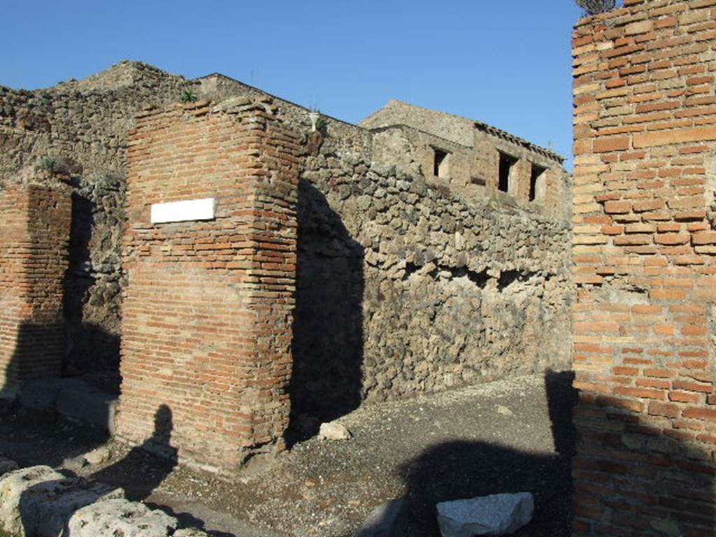 IX.3.9 Pompeii. December 2007. Entrance, looking towards north wall.
On the pilaster that separates these two shops, on the left between IX.3.8 and 9, a mutilated graffiti was found   
Titus ? …  rog(at)   [CIL IV 884]
See Della Corte, M., 1965.  Case ed Abitanti di Pompei. Napoli: Fausto Fiorentino. (p.162)
According to Della Corte, also found on this pilaster on the left, was the graffiti
Multum  pistores  rogant     [CIL IV 886]  
This graffiti was written in support of the candidate Giulio Polibio  (see IX.3.8).
See Della Corte, M., 1965.  Case ed Abitanti di Pompei. Napoli: Fausto Fiorentino. (p. 159)
