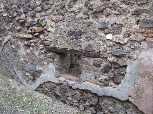 IX.3.20 Pompeii. December 2007. Room 4, east wall and doorway with remains of two terracotta basins. Found in this room were two lead-lined basins to conserve the water: at the rear was the baker’s room.

