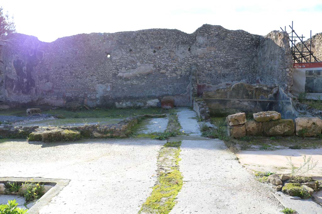 IX.3.22 Pompeii. May 2017. Looking north-west from IX.3.21 towards rear room with painted wall decorations.  Photo courtesy of Buzz Ferebee.
