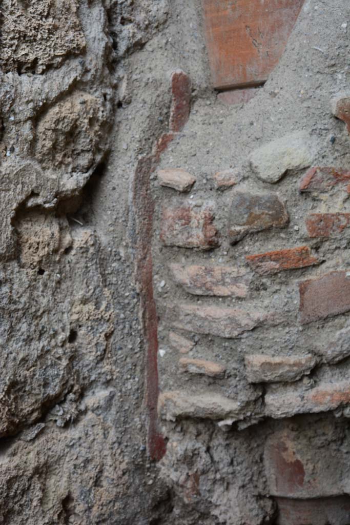 IX.5.4 Pompeii. March 2017. 
Room f, detail of remaining painted plaster on west wall at base of terracotta downpipe.
Foto Christian Beck, ERC Grant 681269 DCOR.
