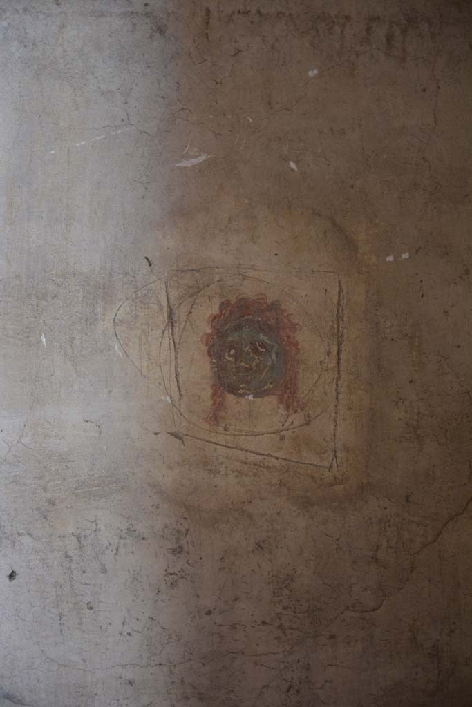 IX.5.6 Pompeii. May 2017. 
Room k, east wall at north end.
According to PPM 
This was a painted vignette of a green female mask on a white background, with eyes, nose, mouth and hair in red.
The encircling incision surrounding it, was a sign of an attempted robbery.
Foto Christian Beck, ERC Grant 681269 DCOR.

