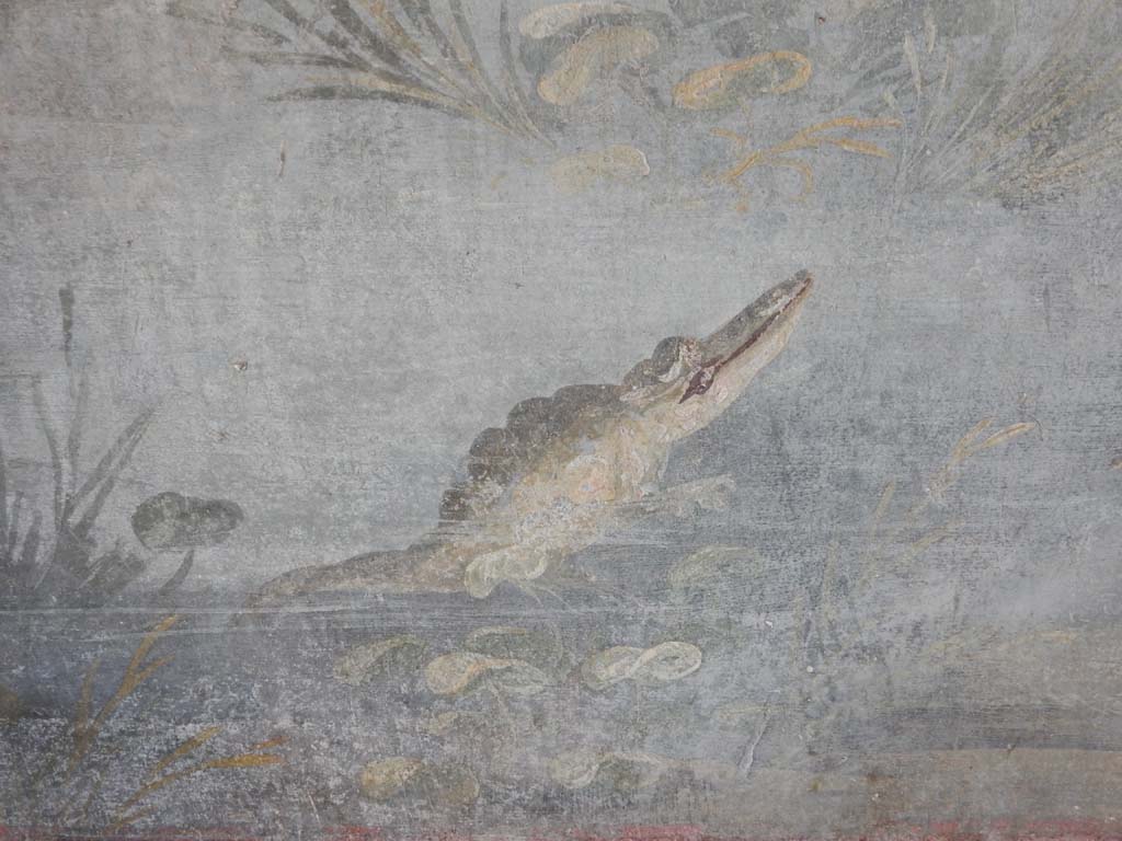 IX.5.9 Pompeii. June 2019. Room 8, north wall at east end, detail of the crocodile. 
Photo courtesy of Buzz Ferebee.
