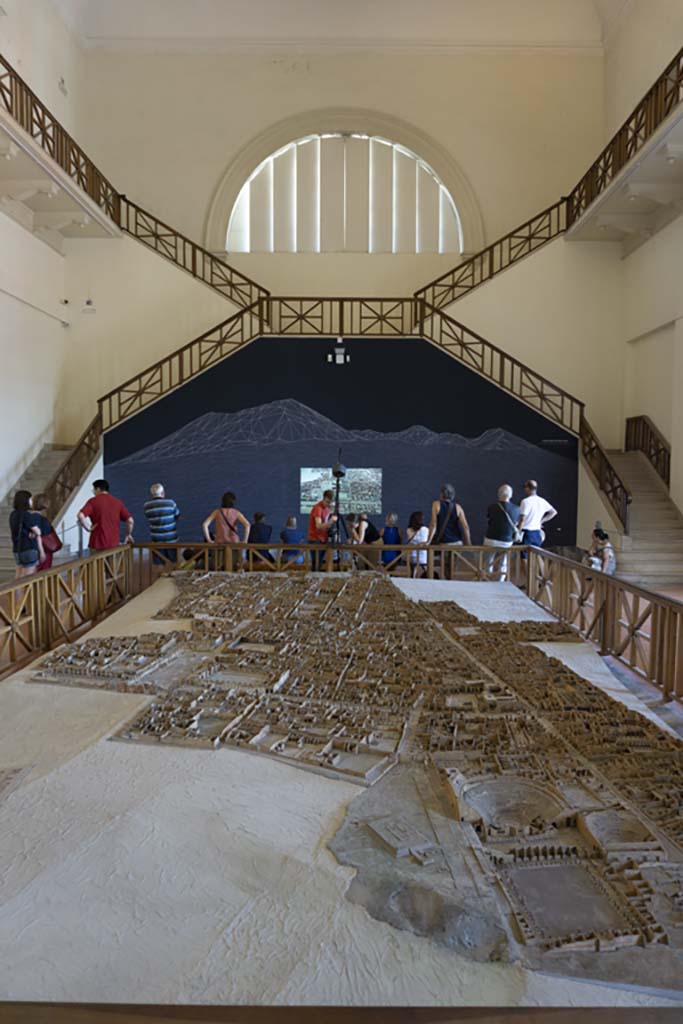 Cork model on display on Naples Archaeological Museum. July 2017.
Looking north from Gladiators Barracks and Theatres at VIII.7 on Via Stabiana, lower right.
Foto Annette Haug, ERC Grant 681269 DÉCOR.
This model in the Naples Archaeological Museum, made of wood, cork and paper, by Felice Padiglione, is scaled at 1/100, and shows the excavations up until the end of 1879.

Many models of the city were produced, including one on display in an exhibition in VIII.2.14/16 in 2018.
That model featured the houses on the western side of VIII.2, that is VIII.2.1/3 the Houses of Championnet, VIII.2.14/16, VIII.2.17/21 the Sarno Baths, and the next few properties on the southern slope.
According to the Archaeological Park of Pompeii display notice in VIII.2.14/16 - 
“The cork model was begun in 1865 by Giovanni Padiglione, one of several models predating the great model of the entire city now in Naples Archaeological Museum. 
It was created over the course of several stages, following the advance of archaeological discoveries, as demonstrated by the Courtyard of the Moray Eels, excavated at the end of the nineteenth century, and the lower floors of the houses which were investigated in the 1930’s.
In addition, the wall and floor decorations, painted on paper, do not correspond with those that were originally present; most probably it was decided to substitute them with those of a more profound impact from other houses, for educational purposes.”
ses.”
