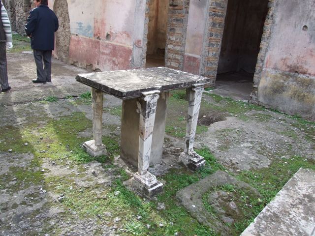 IX.5.11 Pompeii. December 2007.  Room 1.  Atrium.  Cartibulum or marble table.  Looking southwest across to west side of atrium and door ways to rooms 6 and 7.  
