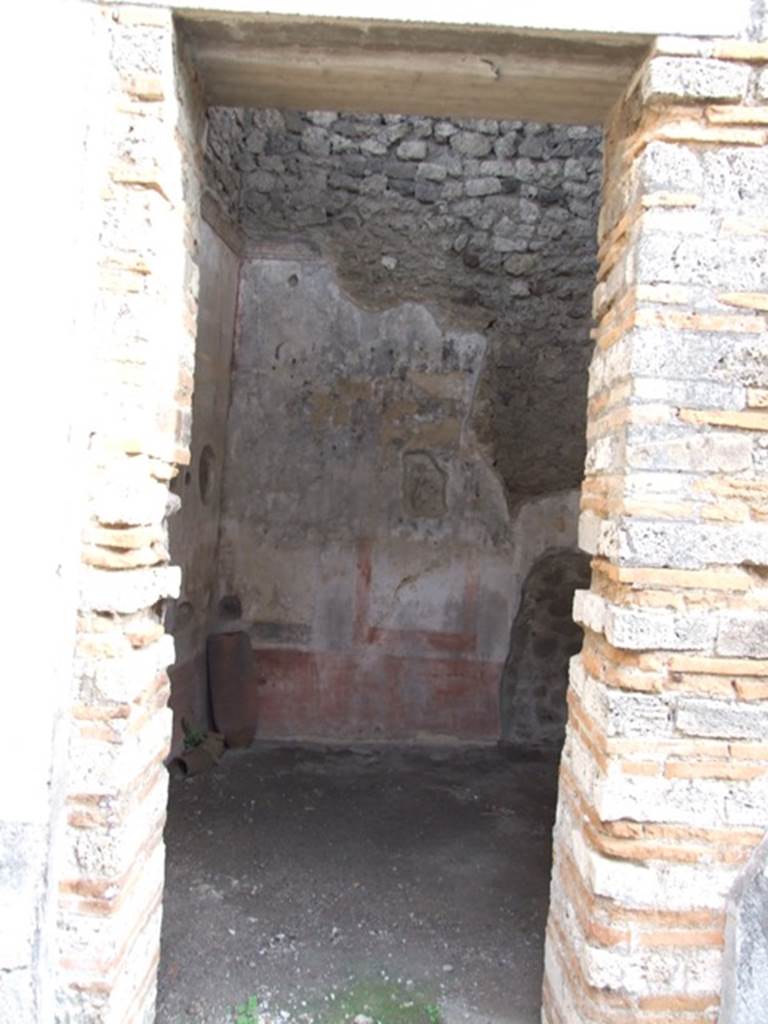 IX.5.11 Pompeii. December 2007. Doorway to room 2, a cubiculum, looking east. The walls of this room would have had a red zoccolo divided into panels by narrow compartments containing painted plants. In the white panels of the middle zone were vignettes with cupids, the upper zone was also white with a stucco cornice.
