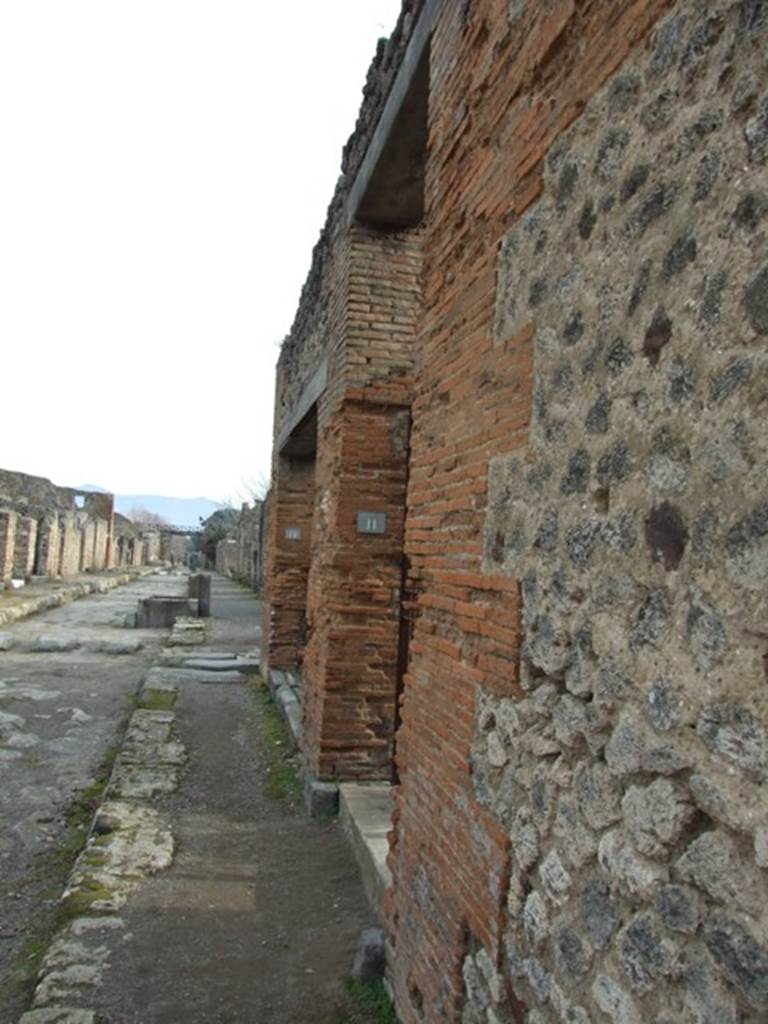 IX.5.11 Pompeii. December 2007. Entrance and view along Via di Nola, looking east.
According to Cooley, the translation of graffito CIL IV 357 found here, is – The Poppaei ask for Helvius Sabinus to be elected aedile.
See Cooley, A. and M.G.L., 2004. Pompeii : A Sourcebook. London : Routledge. (p.121).  According to Epigraphik-Datenbank Clauss/Slaby (See www.manfredclauss.de), this read –
Helvium Sabinum
Poppaei aed(ilem) fiere rog(at)     [CIL IV 357]
