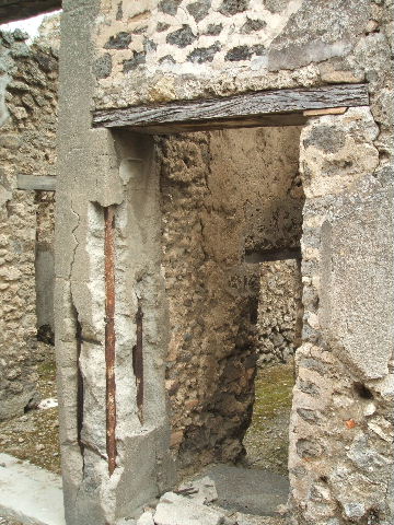 IX.5.20 Pompeii. August 2006. Room “v”, latrine at rear of steps to upper floor. Photo courtesy of Barry Hobson.
See Hobson, B., 2009. Pompeii, Latrines and Down Pipes. Oxford, Hadrian Books, (p. 512). 
