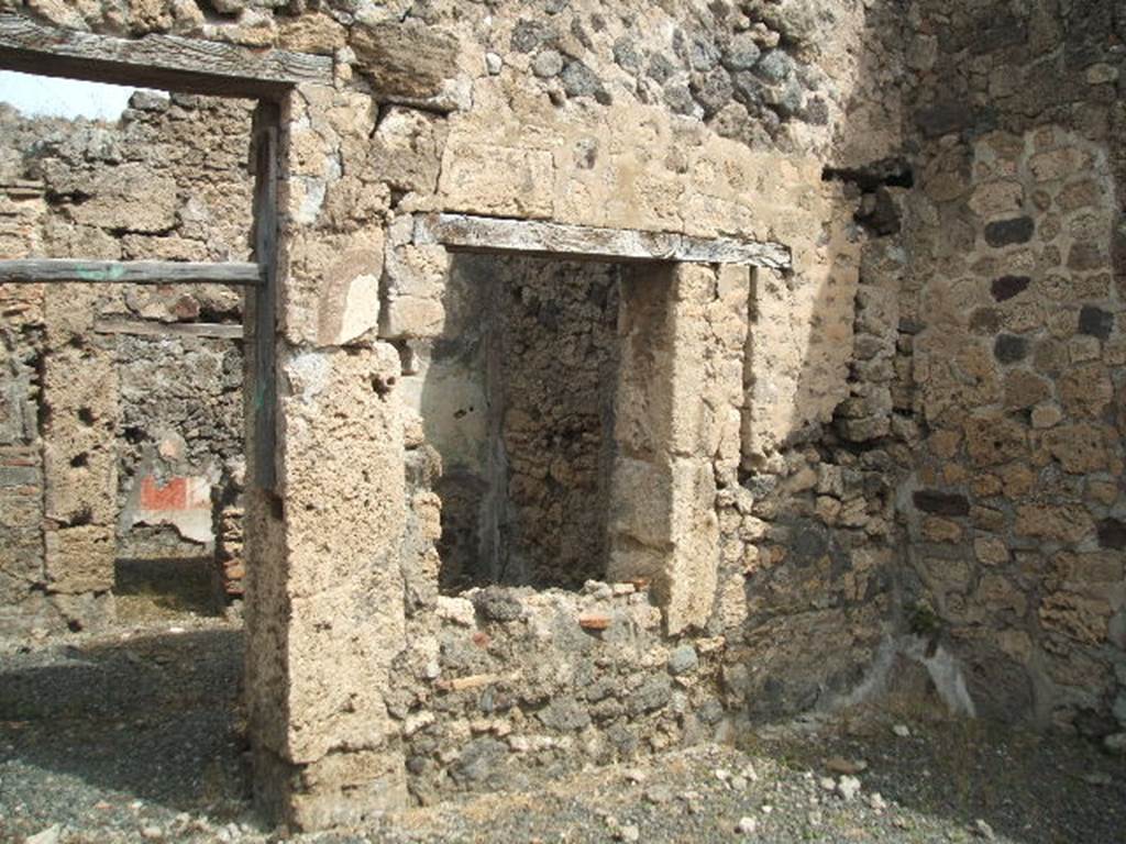 IX.6.e Pompeii. May 2005. North wall of shop, with door and window to IX.6.d