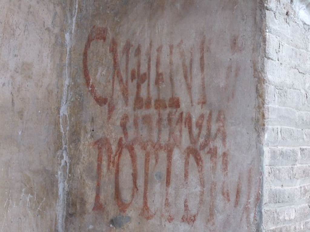 IX.7.5 Pompeii. December 2006. Graffiti outside workshop of Verecundus. According to Epigraphik-Datenbank Clauss/Slaby (See www.manfredclauss.de) CIL IV records this as two entries 
Cn(aeum)  Helvium 
Sabinum    [CIL IV 7831]

Popidium 
aed(ilem)  o(ro)  v(os)  f(aciatis)    [CIL IV 7832] 

Also see Varone, A. and Stefani, G., 2009. Titulorum Pictorum Pompeianorum, Rome: L’erma di Bretschneider. (p. 398)
