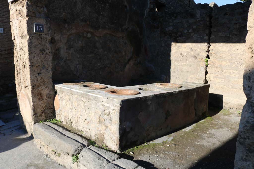 IX.7.13 Pompeii. December 2018. Looking north-west across podium/counter with inset dolia. Photo courtesy of Aude Durand.