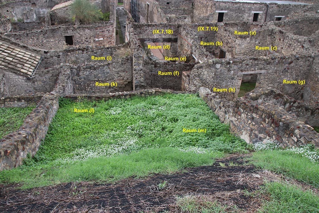 IX.7.19 Pompeii. October 2024. Looking west from rear. Photo courtesy of Klaus Heese.
The rooms (d) and (e), in centre, are also the shop at IX.7.18, which was linked into IX.7.19.
