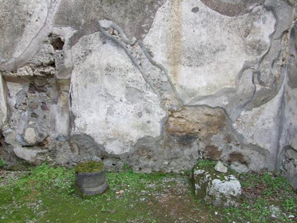 IX.8.7 Pompeii. March 2009. South wall, with stone base of stairs, and line of stairs visible in the plaster. According to Boyce, beneath the stairs leading to the upper floor, a panel of white stucco was bordered with red stripes. On this panel was painted a single serpent, advancing left towards a burning altar, which stood amongst plants. Not. Scavi, 1880, 98. See Boyce G. K., 1937. Corpus of the Lararia of Pompeii. Rome: MAAR 14. (p.90, no.450) 
