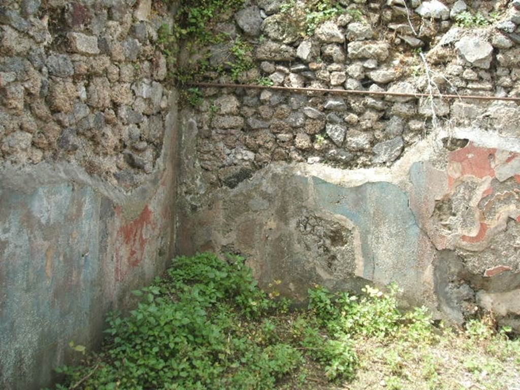 IX.8.c Pompeii.  May 2005.  Room on south side of garden area. South west corner and remains of painted plaster.