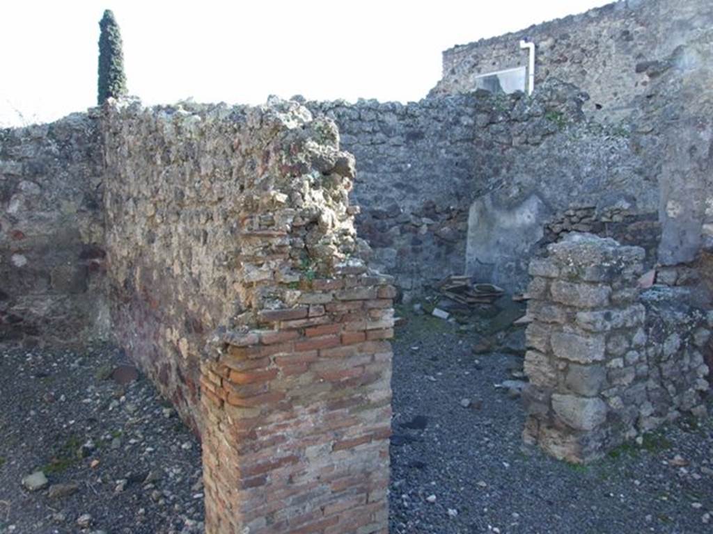IX.9.2 Pompeii. March 2009. Doorway to room “d” in south-west corner of atrium. Room “d” was described as being a windowed cubiculum, with a window into the atrium. At the base of the pilaster between the rooms “e” and “d” was the mouth of a cistern.
