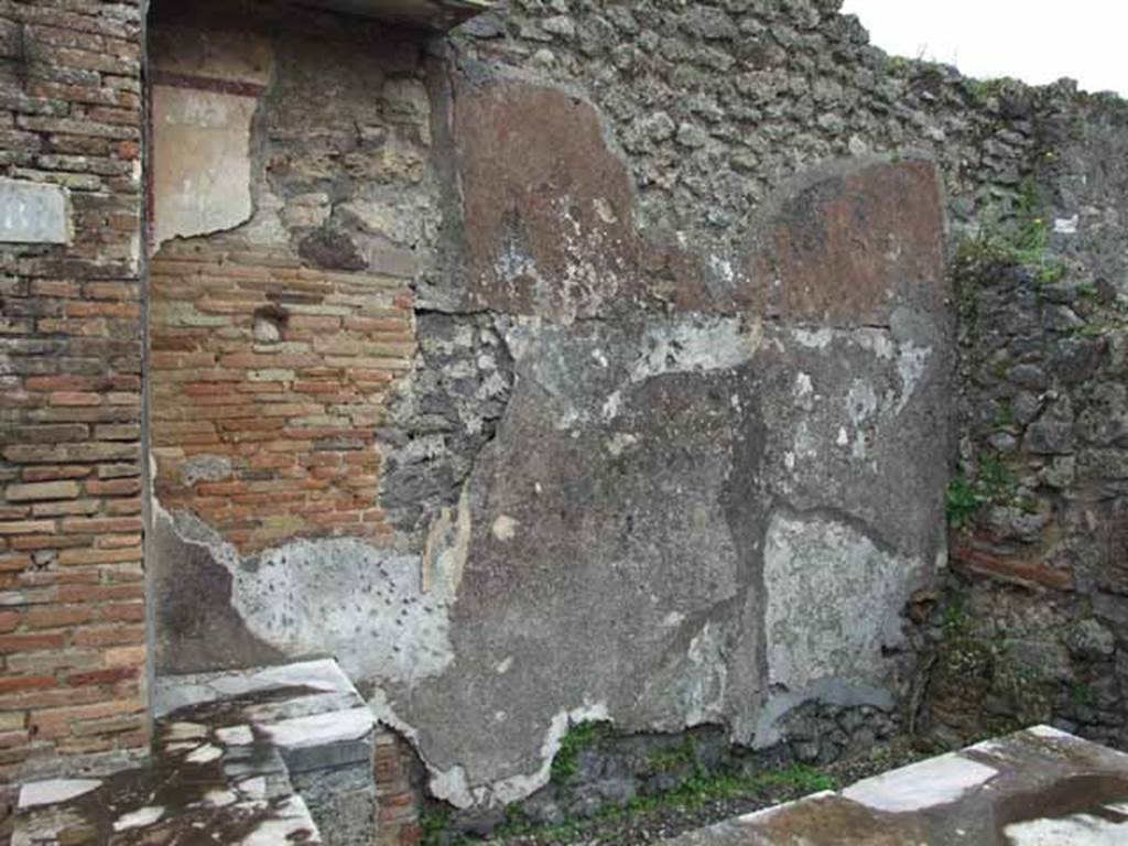 IX.9.8 Pompeii. May 2010. East wall behind counter.