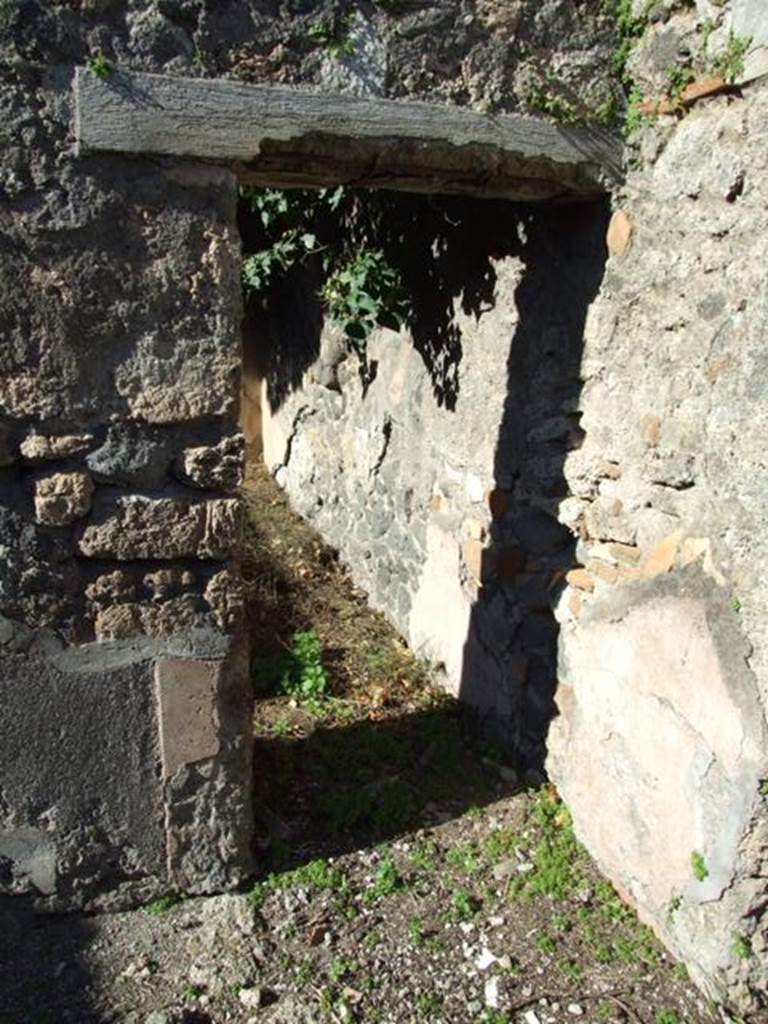 IX.9.11 Pompeii.  March 2009.  Doorway to Room 7, large Triclinium on north side of garden area.
