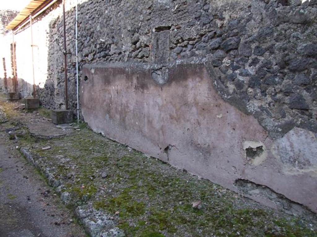 IX.9.d Pompeii. March 2009. Looking north along east side of vicolo.Exterior plastered and painted street wall between IX.9.c and IX.9.d.  
