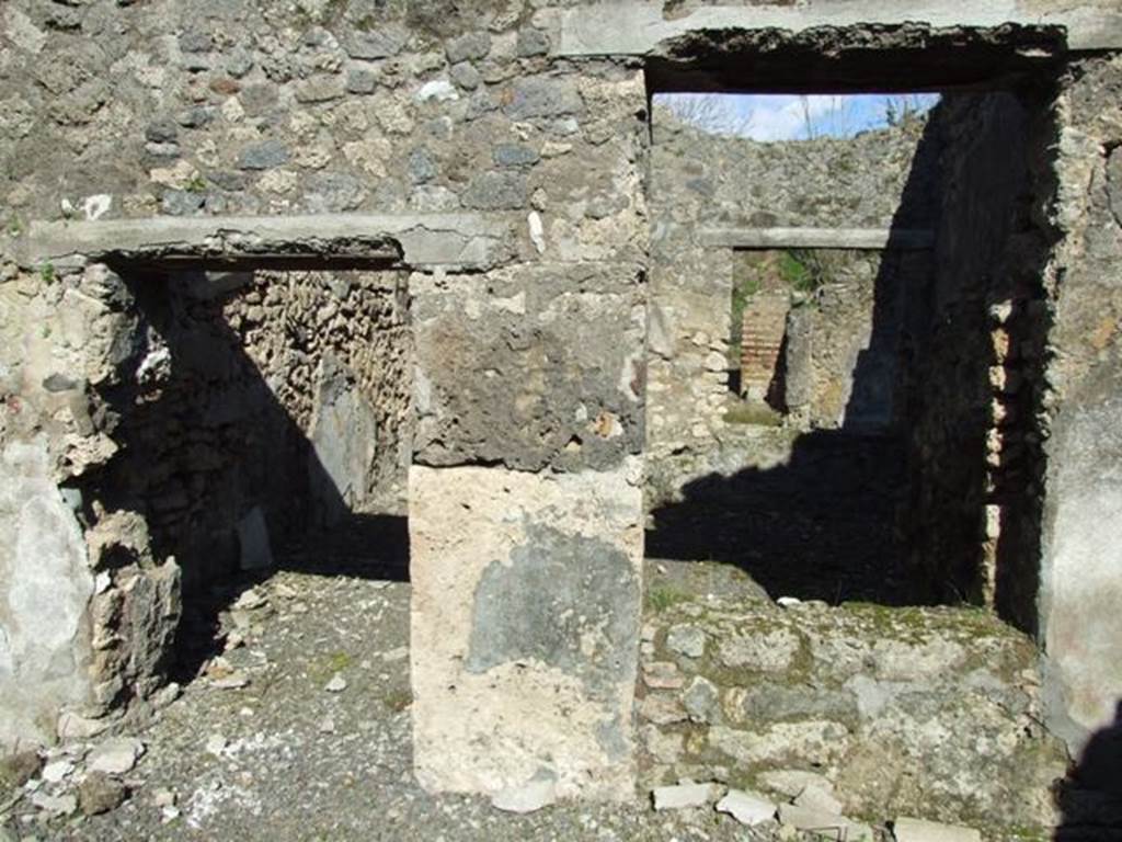 IX.9.e Pompeii. March 2009. Room 17, east wall of atrium, with doorway and window to room 16, the light-yard. 