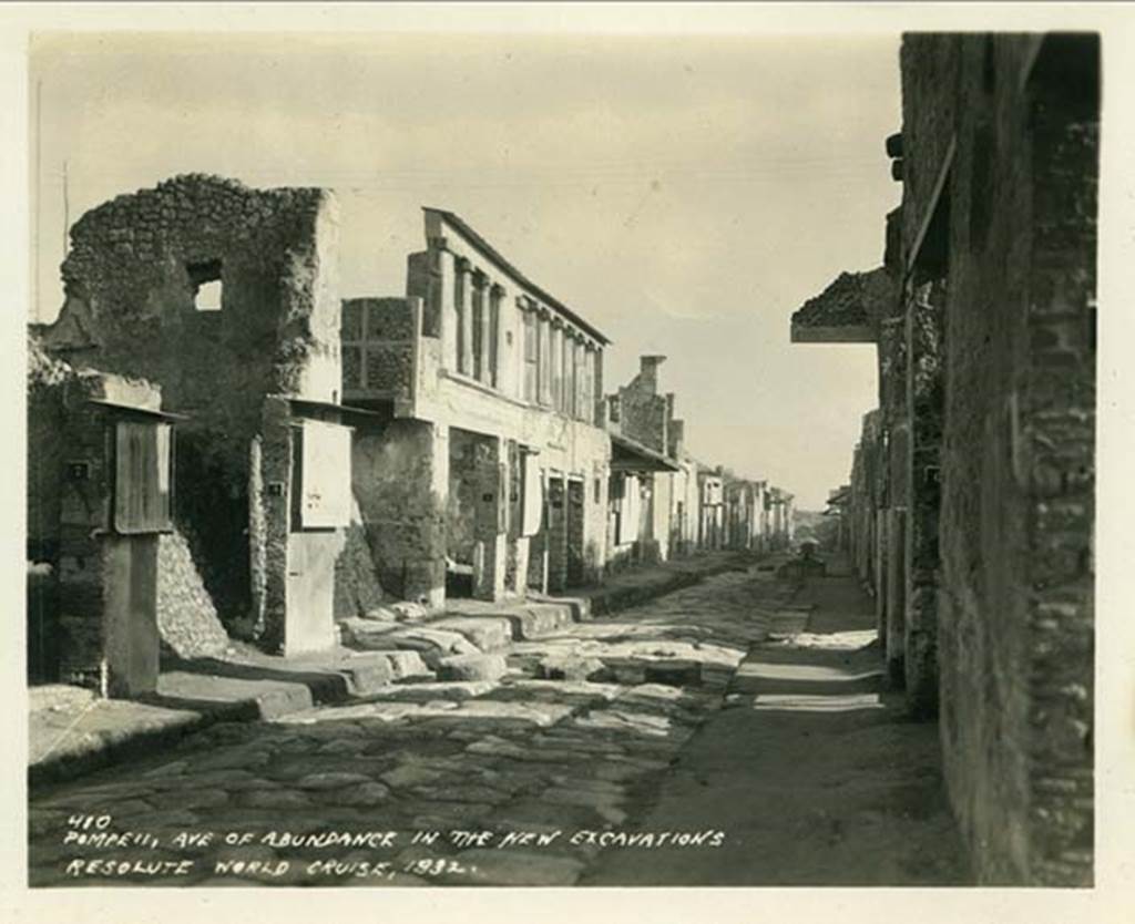 IX.11.8 Pompeii. 1932, looking east on Via dell’ Abbondanza. The doorway to IX.11.8 can be seen on the left, between two “protected” graffiti, and with a high end wall with window. 
Photo taken during a shore-visit from the ship Resolute’s world cruise in 1932. Photo courtesy of Rick Bauer.

