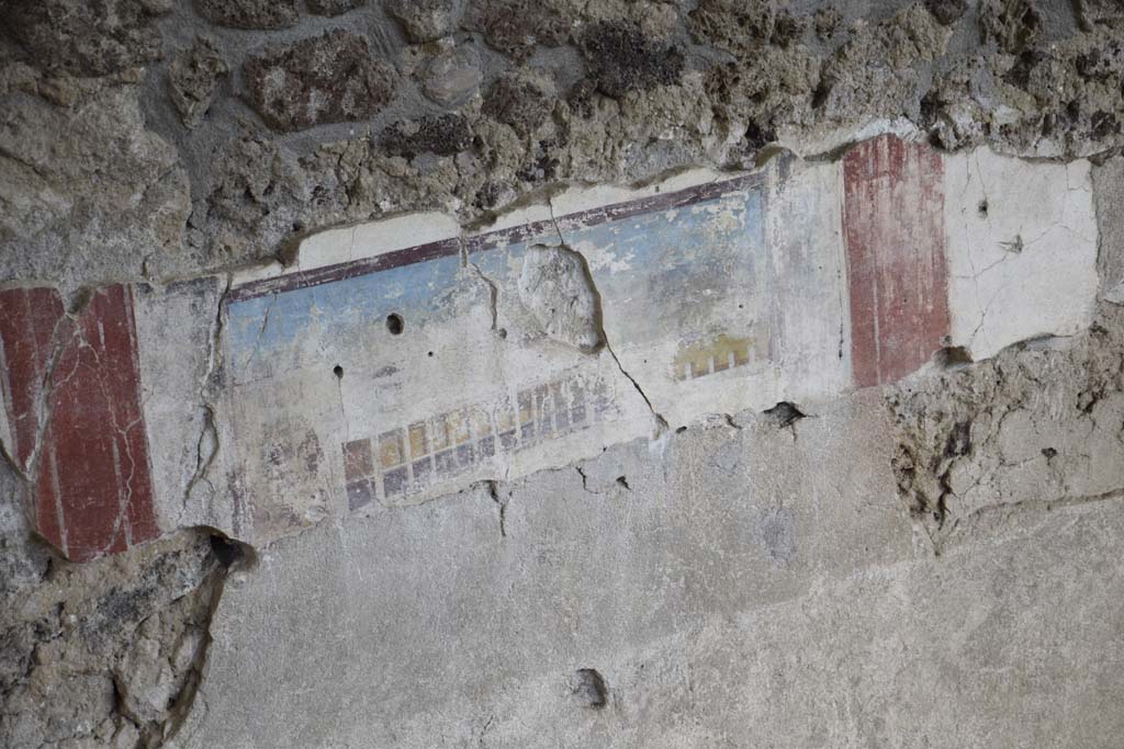 Detail of painted east wall in room being excavated, on west side of bakery at IX.12.6. 
