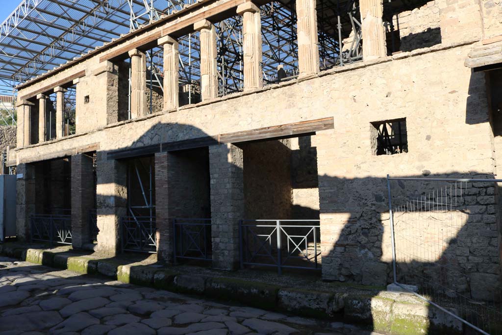 IX.12.1-5 Pompeii. December 2018. Looking west along front façade, with IX.12.5, centre right. Photo courtesy of Aude Durand.