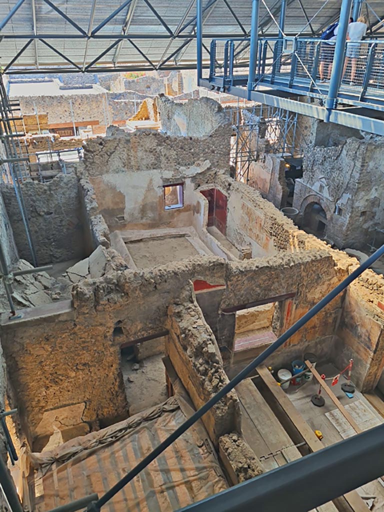 IX.12.6 Pompeii, June 2024. 
Looking south from above rooms “n” and “m”, towards rooms “o”, “n1” and “f”, bakery room with oven “d”. 
Photo courtesy of Giuseppe Ciaramella.

