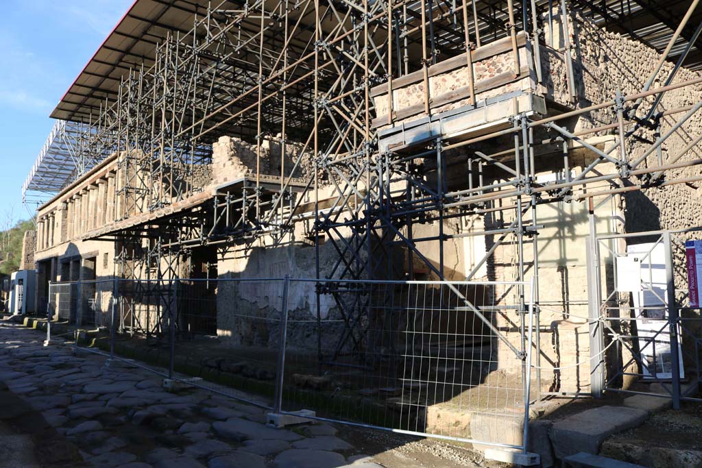 IX.12.7 Pompeii, on right. December 2018. 
Looking west along front façade, from IX.12.7 towards IX.12.1, on left. The street altar can be seen on the right. 
Photo courtesy of Aude Durand.
