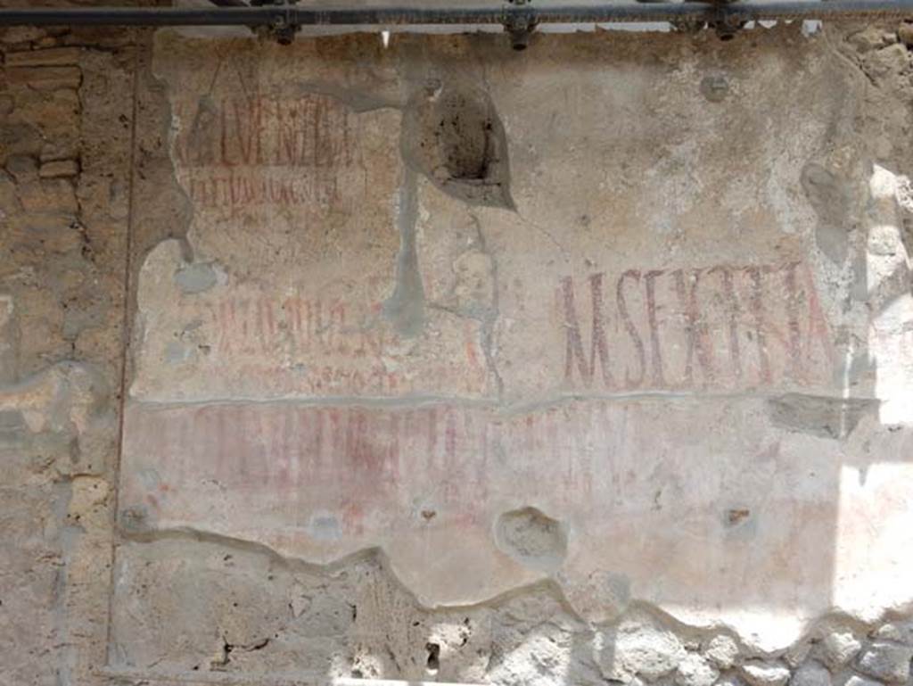 IX.12.7  Pompeii, May 2018. Graffiti between IX.12.6 and IX.12.7. Photo courtesy of Buzz Ferebee.