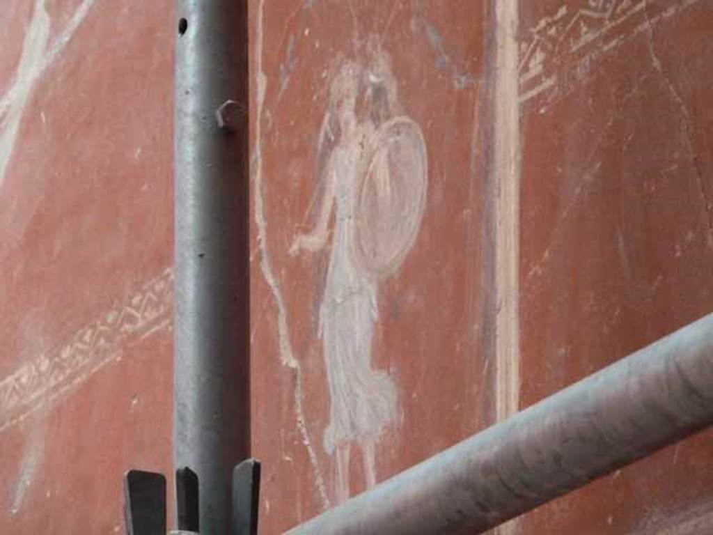 IX.12.9. May 2010. Room 14, south wall, upper zone, centre. Painting of figure with shield.