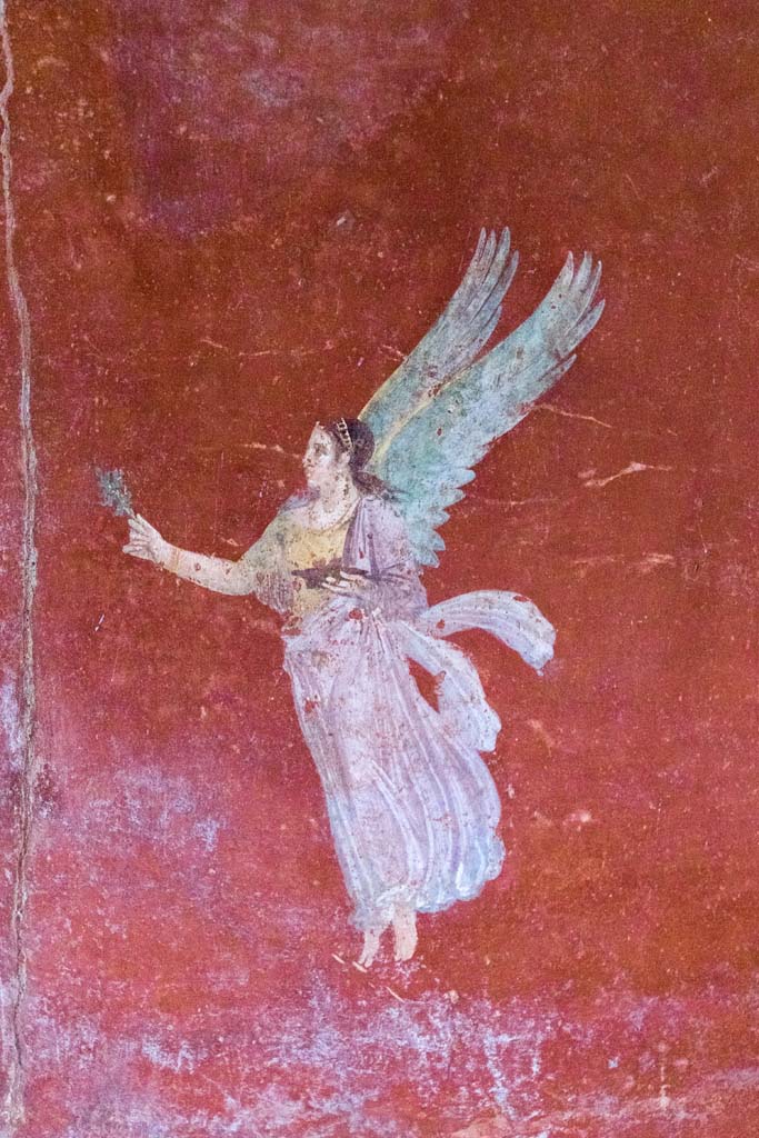 IX.13.1-3 Pompeii. October 2021. 
Room 13, detail of floating figure from east wall. Photo courtesy of Johannes Eber.
