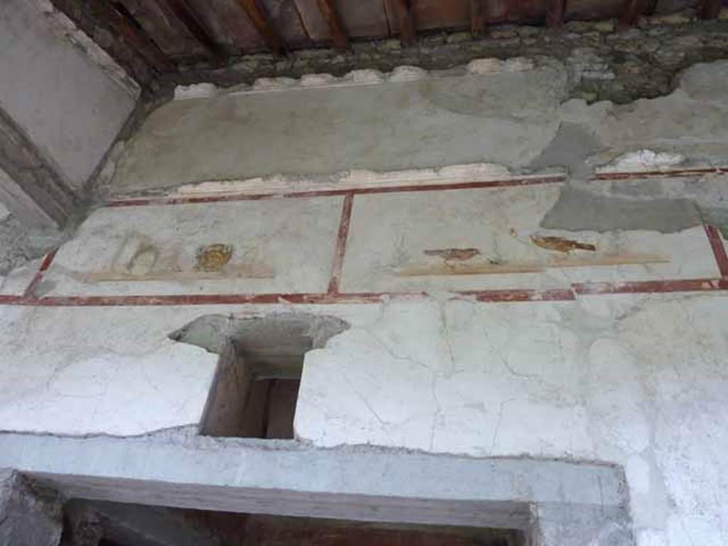 IX.13.1-3 Pompeii. May 2010.  Room 9, upper level on north wall of north portico, above the doorway to room 12.