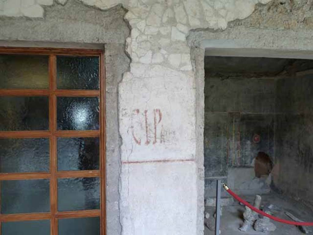 IX.13.1-3 Pompeii. May 2010. Room 9, south wall with painted graffiti between window of room 14, and doorway to room 15.