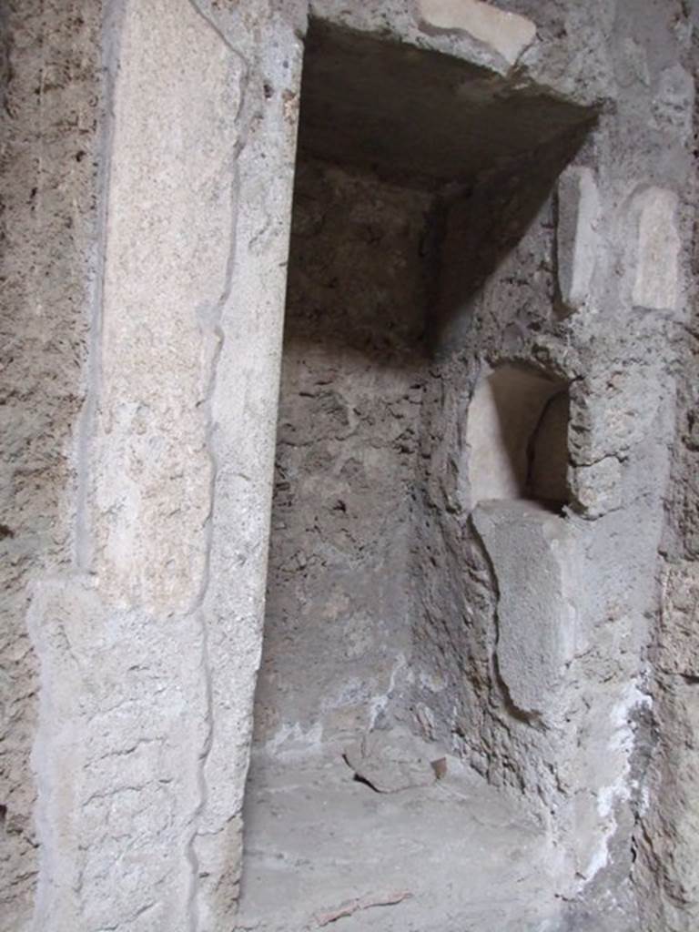 IX.13.1-3 Pompeii. March 2009. Room 2, north-east corner of atrium. 
Recess with 1 niche above, and 1 niche in east side.

