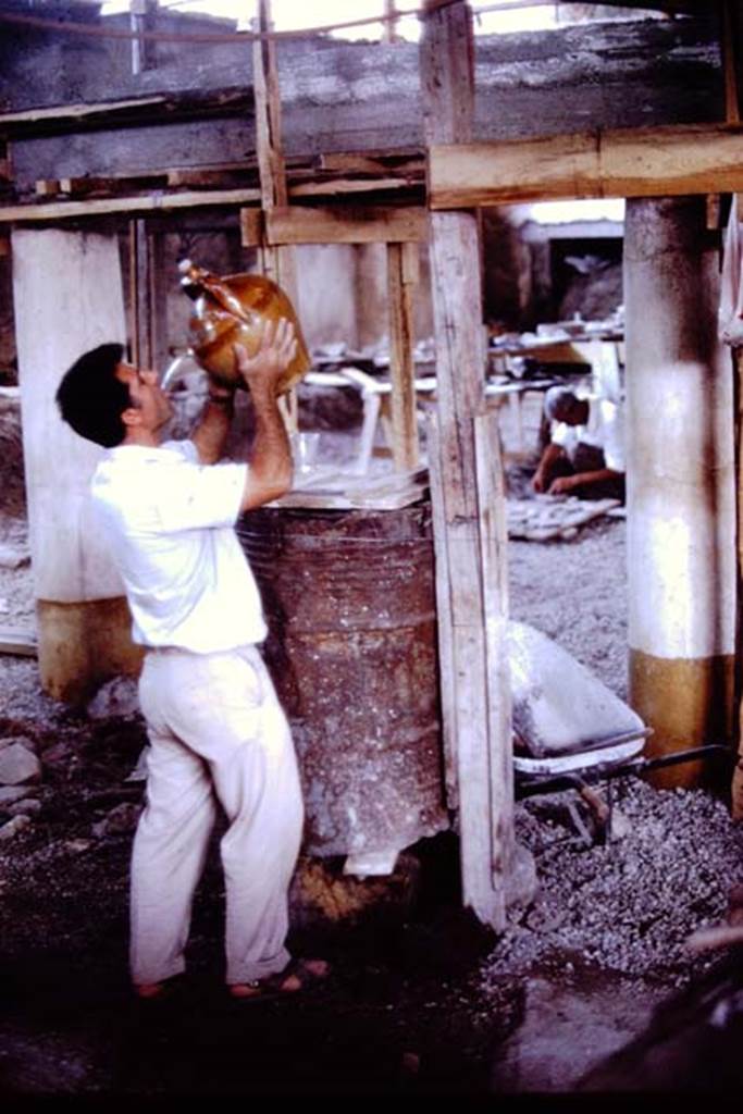 IX.13.1-3 Pompeii. 1972. Drink during excavations. Photo by Stanley A. Jashemski. 
Source: The Wilhelmina and Stanley A. Jashemski archive in the University of Maryland Library, Special Collections (See collection page) and made available under the Creative Commons Attribution-Non Commercial License v.4. See Licence and use details. J72f0464
