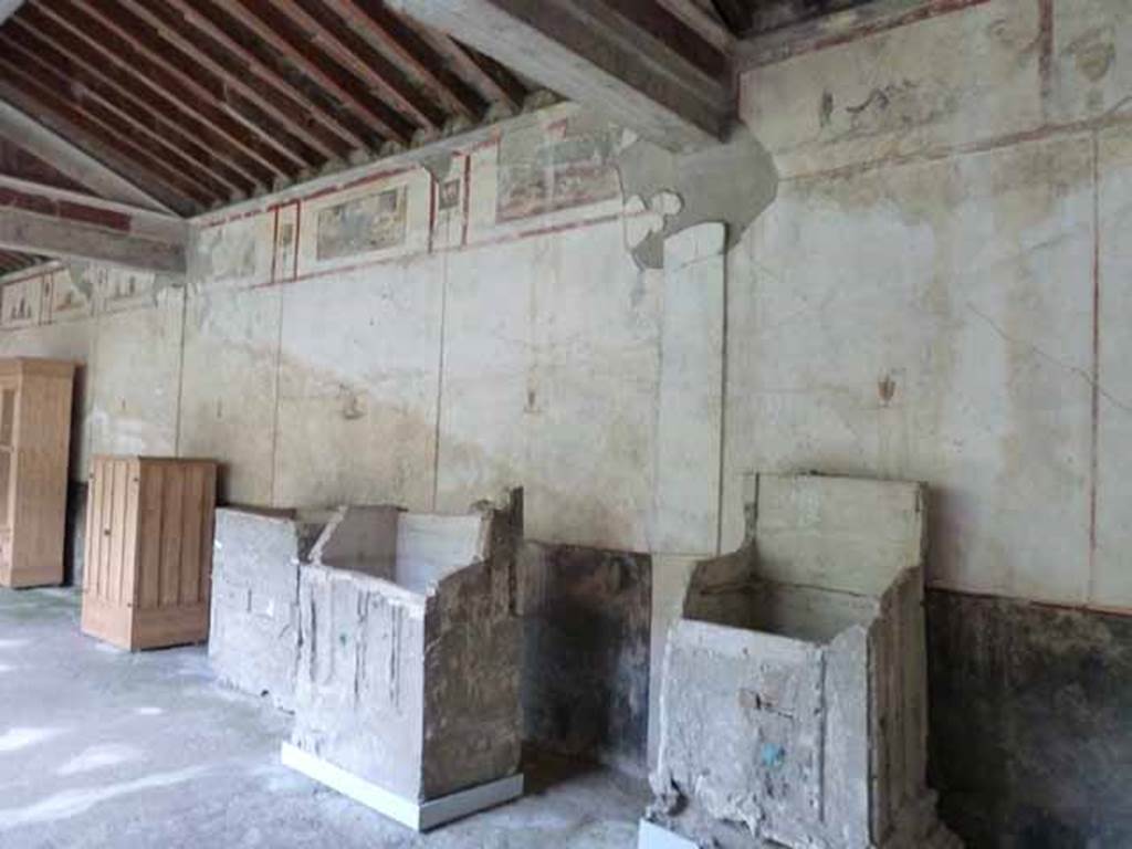 IX.13.1-3 Pompeii. May 2010.  Room 9, east wall of portico and plaster casts of cupboards.