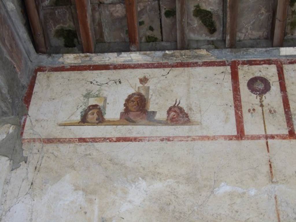 IX.13.1-3 Pompeii. March 2009. Room 9, north end of east wall. Painting of masks or heads.