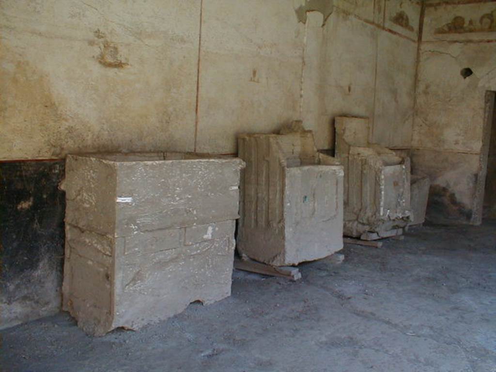 IX.13.1-3 Pompeii. September 2004. Room 9, plaster casts of cupboards or chests against east wall.