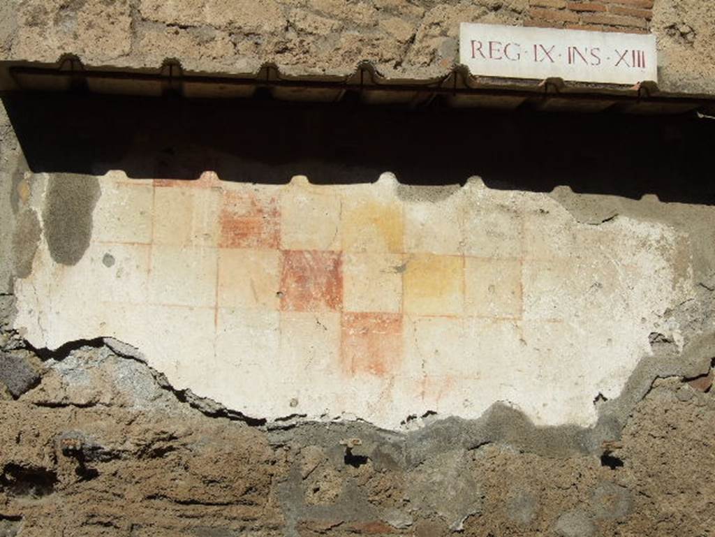 IX.13.6 Pompeii.  December 2005. Plaster with chessboard pattern to east of entrance.