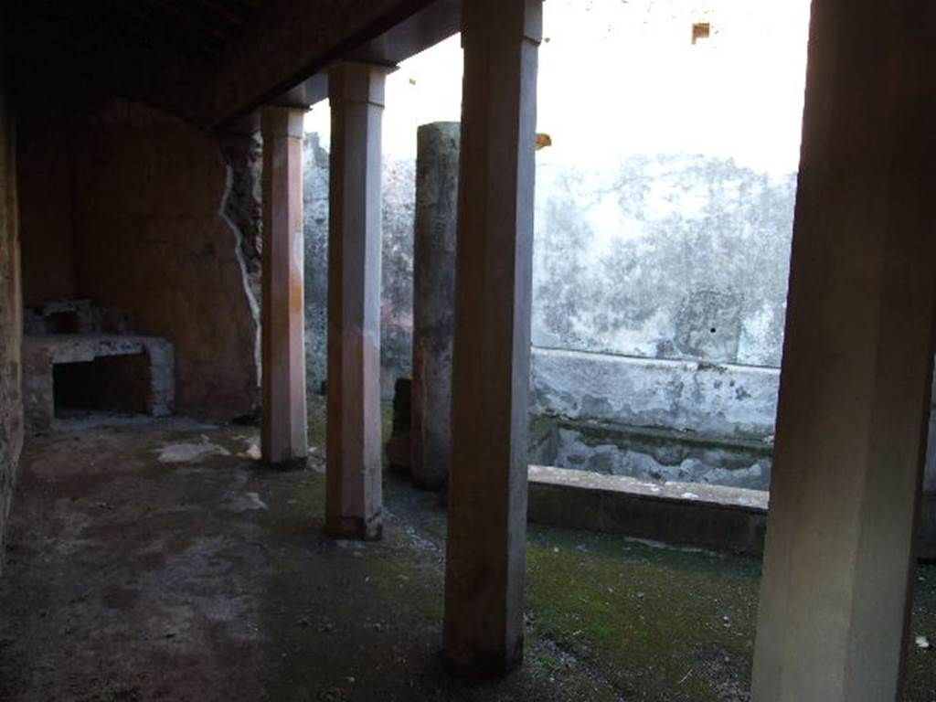 HGW24 Pompeii. December 2006. Looking north along west side of small triangular courtyard, part of baths complex. 
