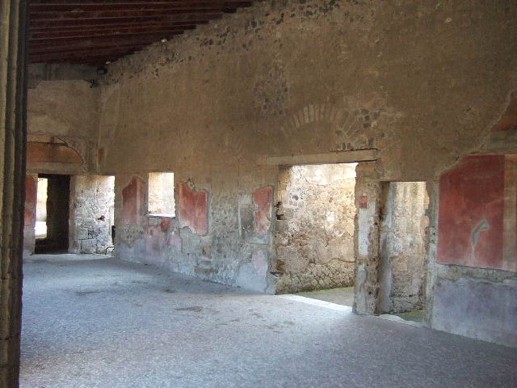 Villa of Mysteries, Pompeii. May 2006. 
Doorways to rooms 21, 26, corridor 27 leading towards the wine-making area, and room 28 on peristyle D. Looking north-west.
