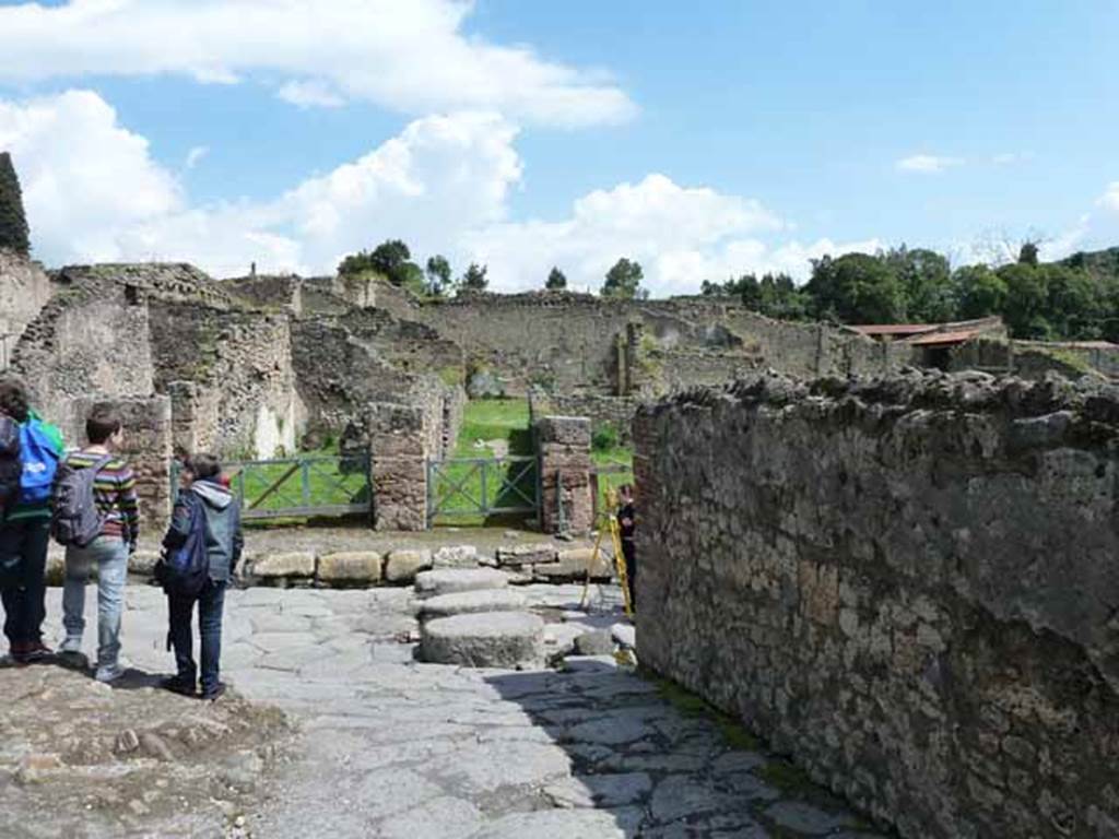 Via Stabiana, west side, May 2010. Looking east to Via Stabiana from alleyway entrance of Gladiator’s Barracks, at VIII.7.16.