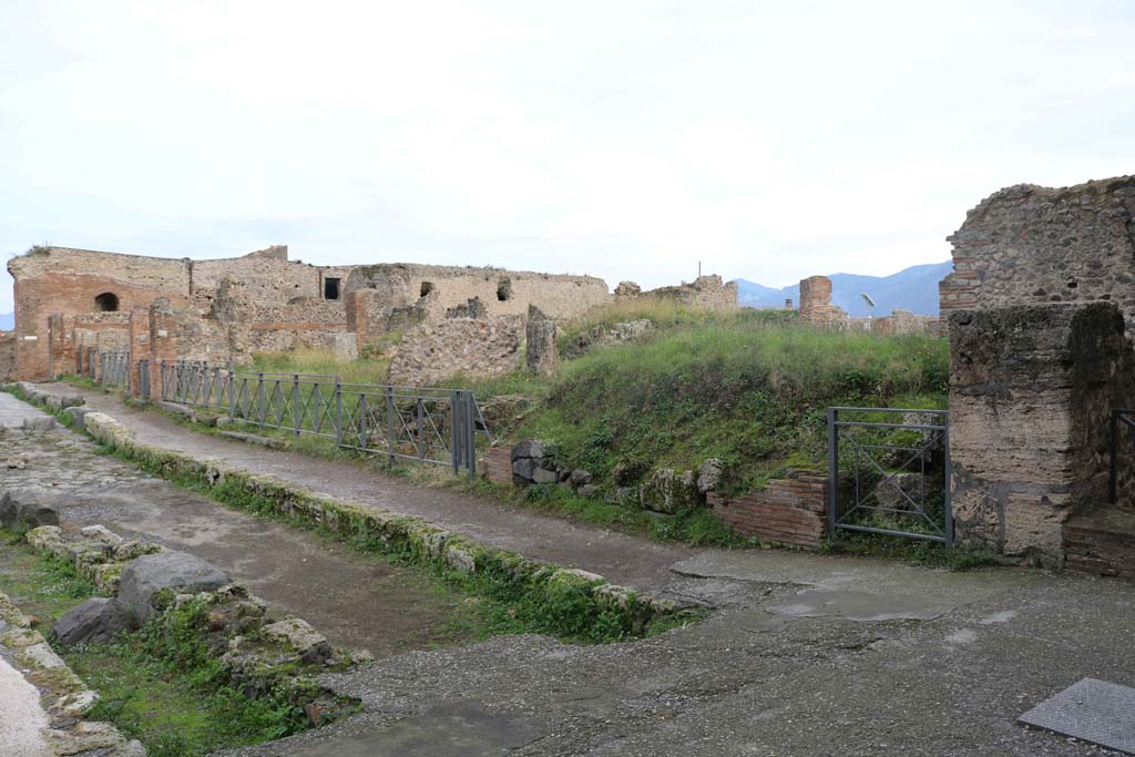 Via delle Terme, south side, Pompeii. December 2018. 
Looking east from junction with Vicolo del Farmacista, on right, from VII.6.1 towards VII.6.15. Photo courtesy of Aude Durand.
