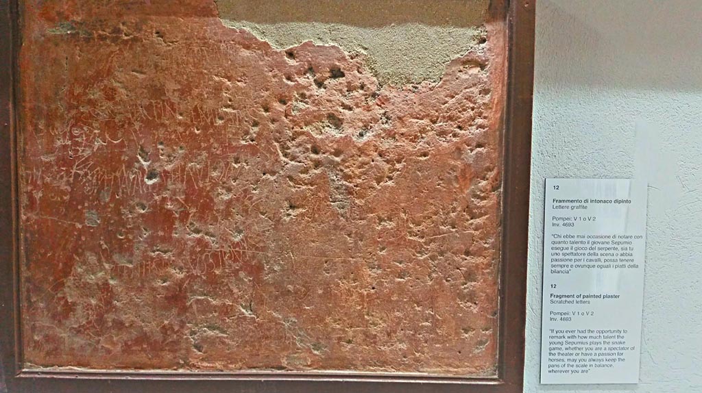 V.1 or V.2, Pompeii. 
Fragment of red painted plaster with scratched letters, found somewhere in one of the properties in V.1 or V.2.
Now in Naples Archaeological Museum, inv. 4693, photo courtesy of Giuseppe Ciaramella, June 2017. 
