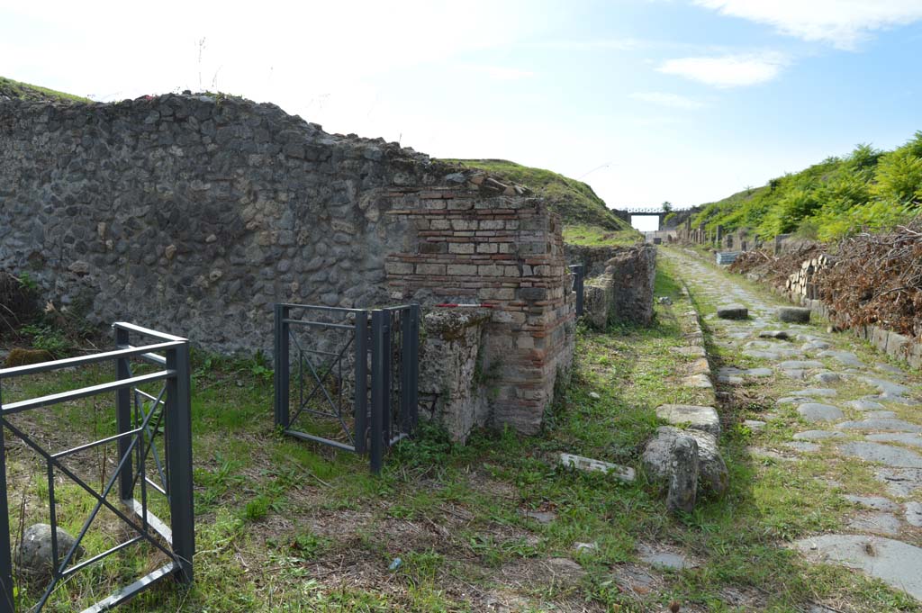Via di Nola, south side, Pompeii. October 2018. 
Looking west on Via di Nola towards street altar, behind gate on side wall of III.10.6, on north-east corner of Insula III.10.
Foto Taylor Lauritsen, ERC Grant 681269 DÉCOR.



