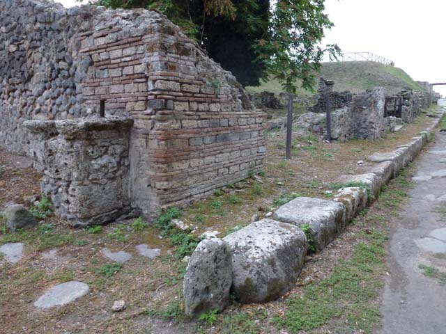 Via di Nola, south side, September 2011. Looking west towards unexcavated vicolo with street altar, on left, and III.10.6 on right.  Photo courtesy of Michael Binns.
